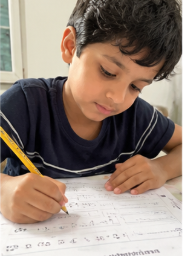 A child doing Mamapick worksheets