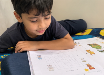 A child doing Mamapick worksheets
