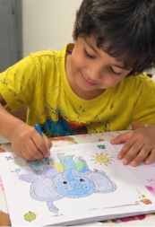 A child doing Mamapick worksheets
