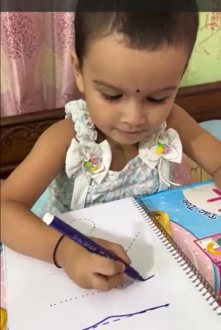 A child doing Mamapick worksheets
